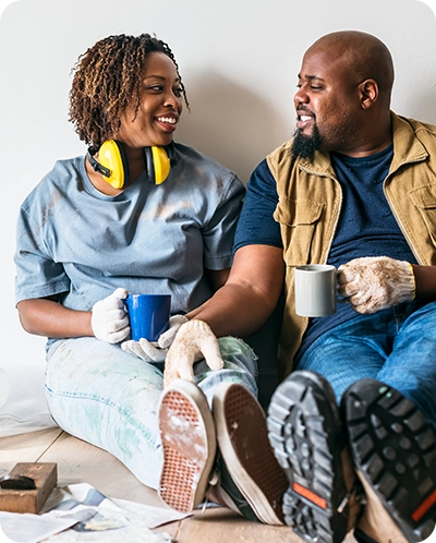 happy couple smiling as they take a break from renovating