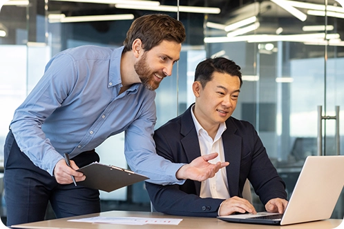 business men discussing something on their computer