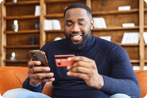 Man buying something on his phone with a Midland debit card