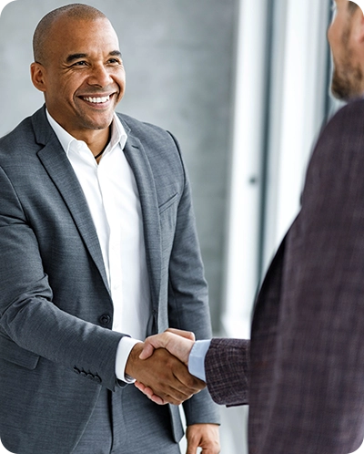 business man shaking hands with another business man