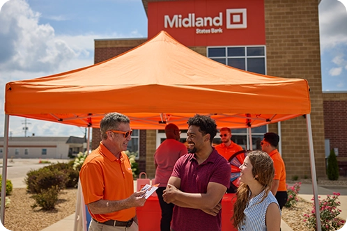 Midland employee talking with customers at event outside