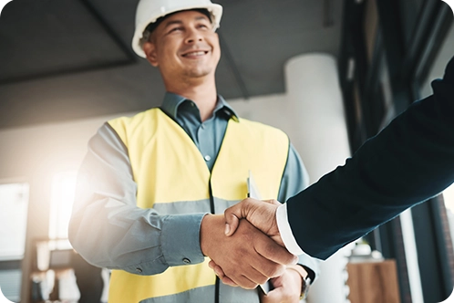 construction worker shaking business man's hand