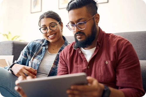 couple looking content as they look at tablet