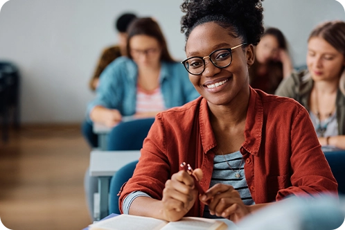 woman smiling while sitting in classroom