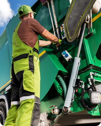 trash man standing next to trash truck