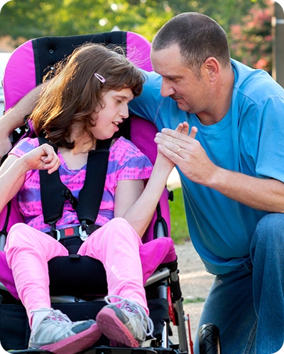 father and special needs daughter embracing outside