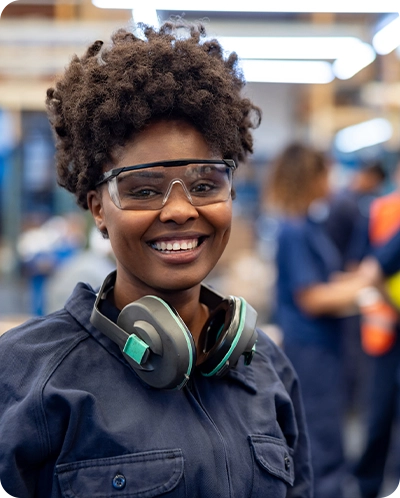 smiling woman working at manufacturing plant