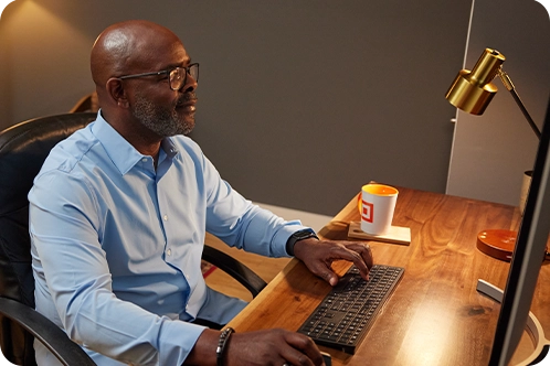 older man looking at computer