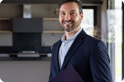 mortgage loan officer standing in house smiling at camera