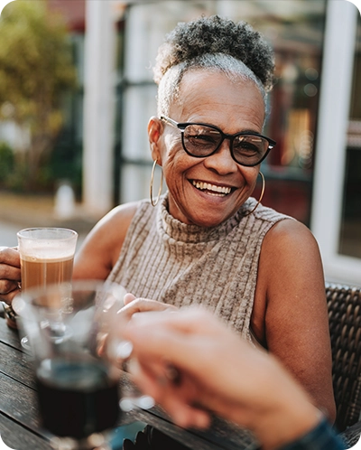 older woman enjoying coffee with a friend