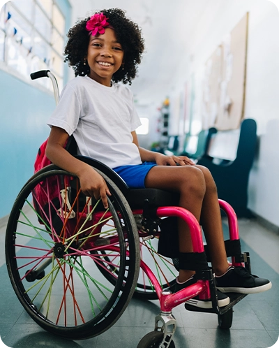 little girl smiling while sitting in her wheelchair