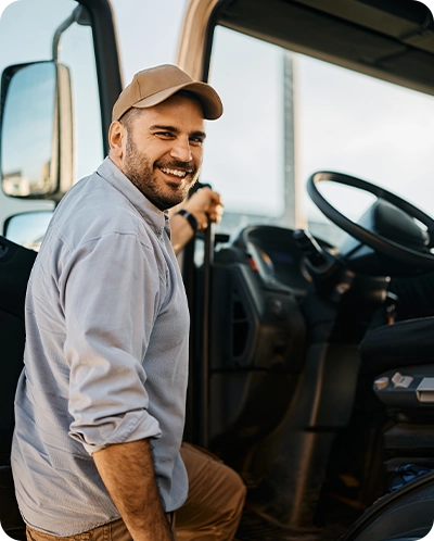 smiling truck driver getting into his semi