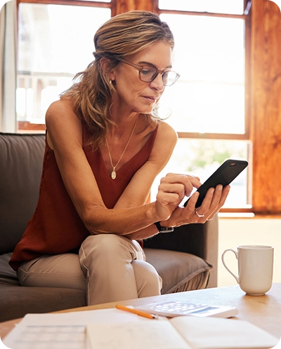 woman looking at Midland wealth features on phone